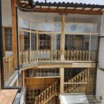 Restored courtyard solarium with sliding glass door and gas firepit