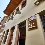 Wide view of the restored historic exterior and entrance to Nucallacta apartment