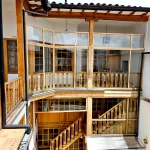 Restored courtyard solarium with sliding glass door and gas firepit