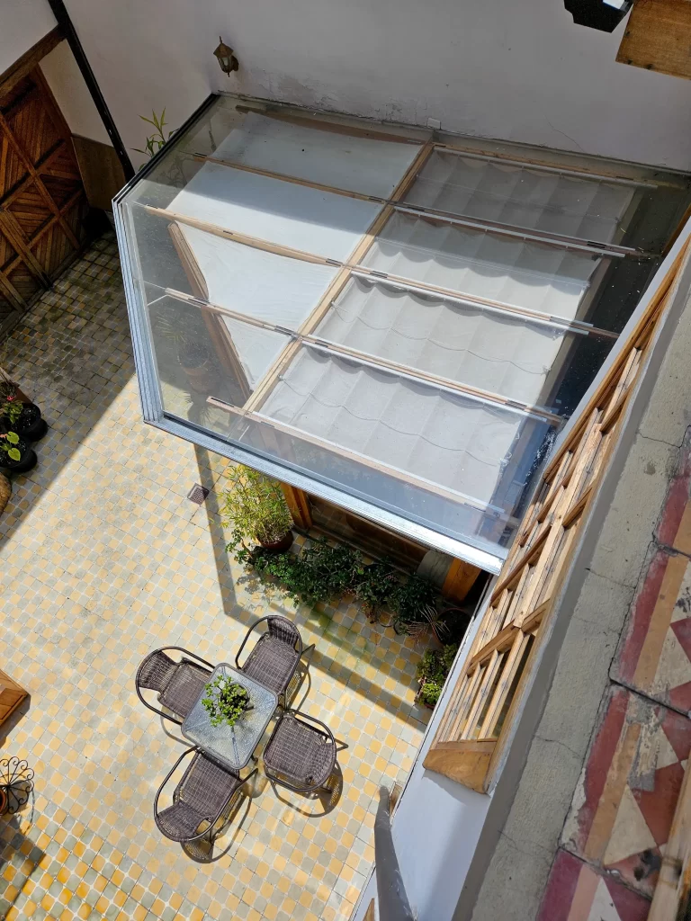 Waterproof glass-enclosed courtyard lounge with integrated lighting