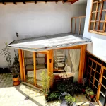 Climate-controlled solarium with interior fabric light diffusion shades