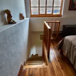 Interior view of the Morgan Suite showing the window and stairs leading to the bedroom area